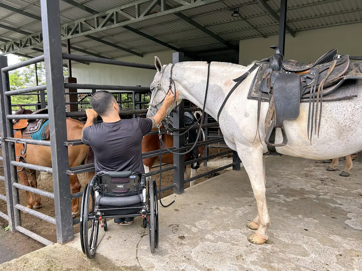 Image shows a wheelchair user getting ready to ride a horse in Arenal, Costa Rica