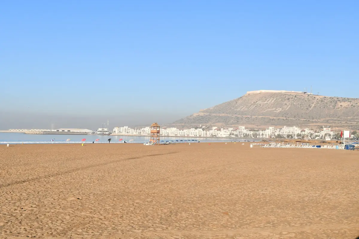 Image shows a wide, sandy beach at Agadir, Morocco